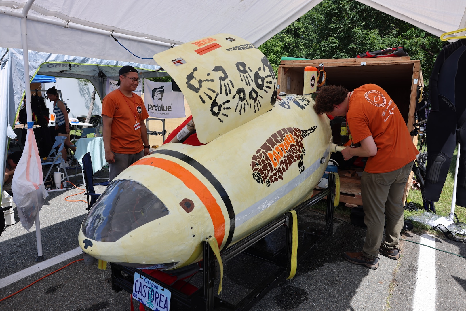 Students from Oregon State University work on their submarine, Castorea, at the 18th International Submarine Races held at NSWC Carderock Division
