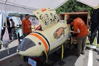 Students from Oregon State University work on their submarine, Castorea, at the 18th International Submarine Races held at NSWC Carderock Division