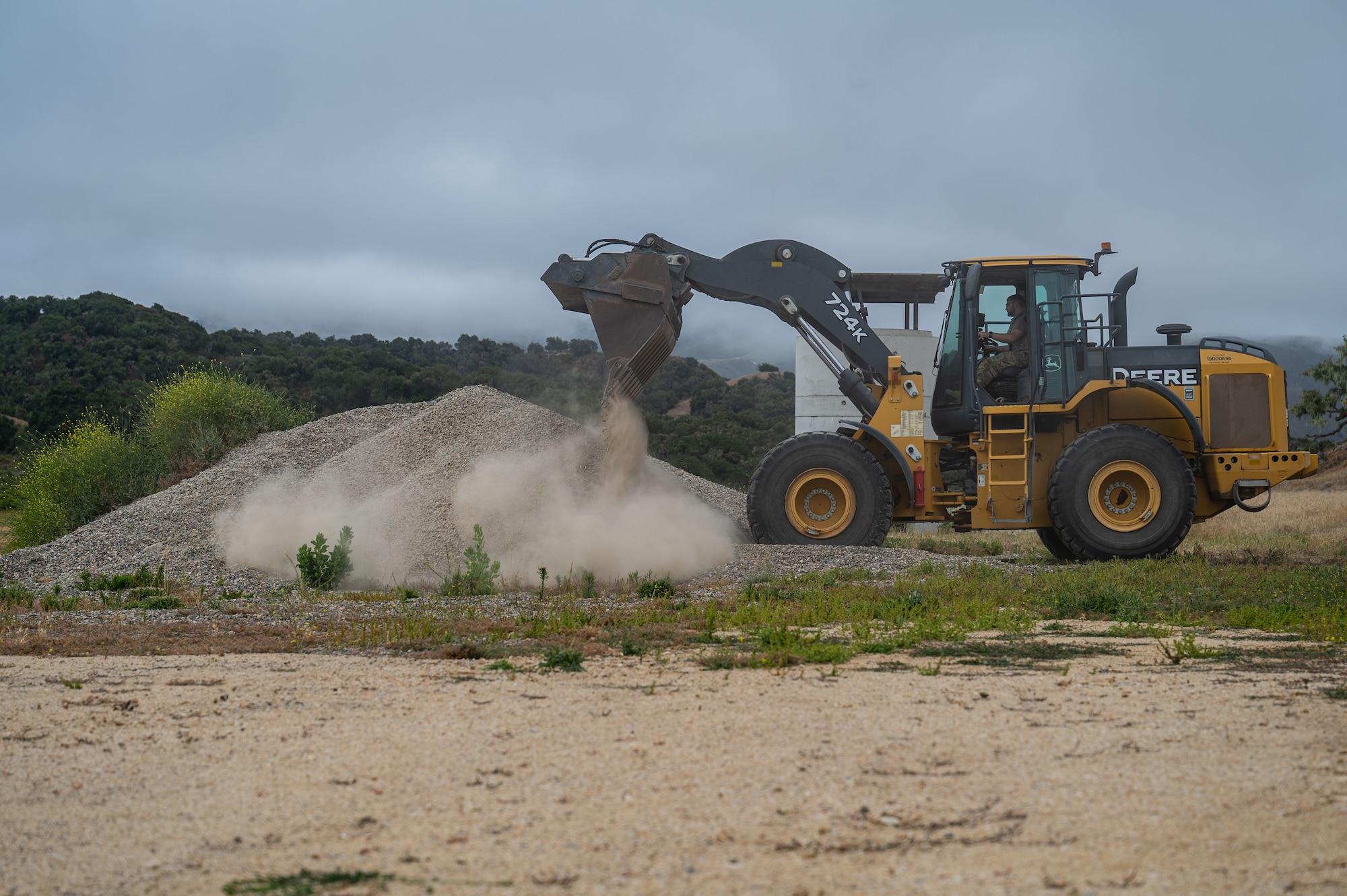 A 30th Civil Engineer Squadron member dumps gravel onto a pile with heavy machinery during 30 CES’s Prime BEEF Day event at Vandenberg Space Force Base, Calif., June 26, 2025. Prime BEEF, or a Prime Base Engineer Emergency Force, is a specialized unit within the civil engineer career fields that can deploy on a moment's notice to carry out specific wartime tasks, such as rapid airfield damage repair and base construction buildup.