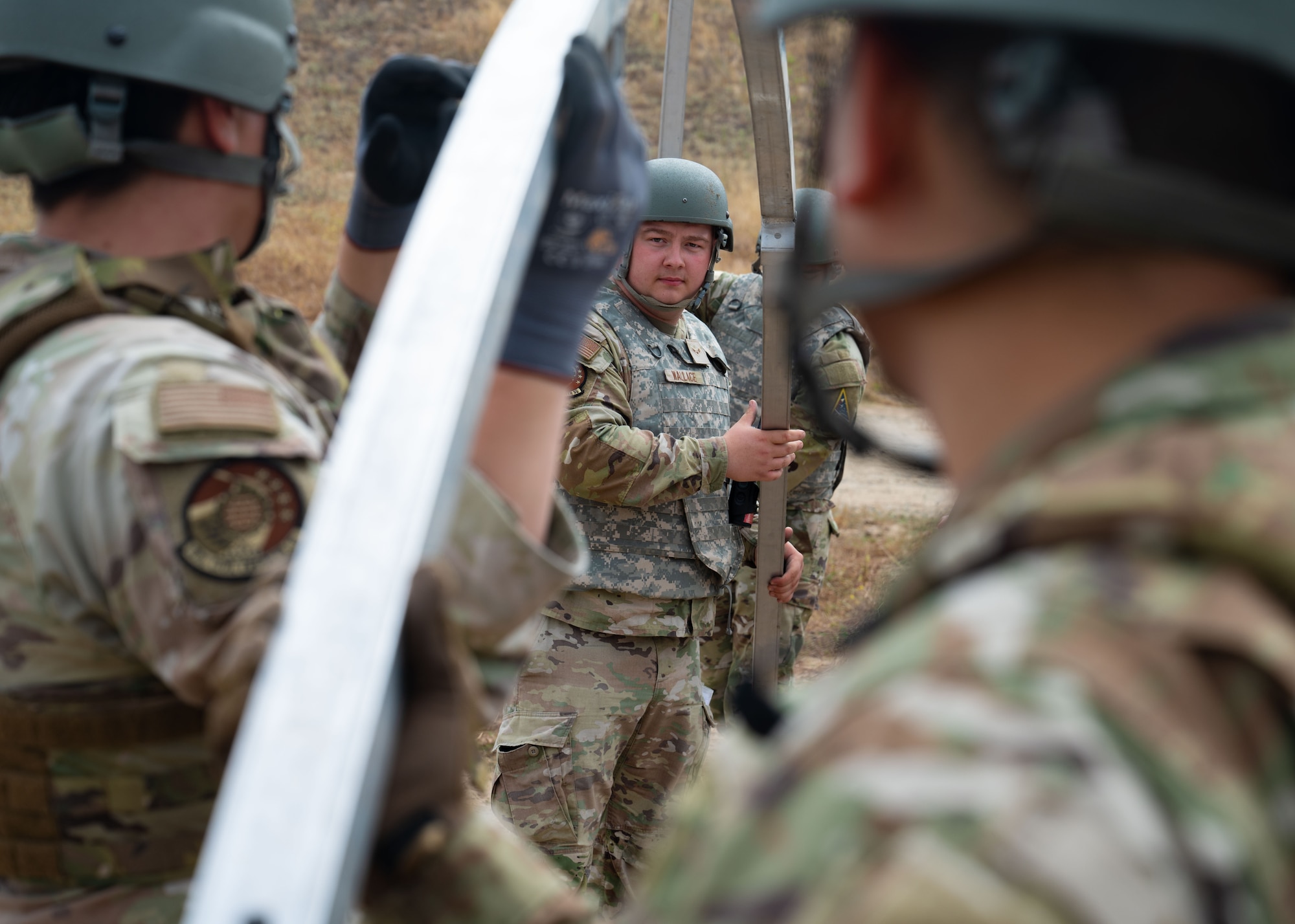 Airman 1st Class Calvin Wallace, 30th Civil Engineer Squadron water and fuel systems maintenance apprentice, works alongside his wingmen to lift arches to a TEMPER tent, or Tent Extendable Modular Personnel, during the 30 CES’s Prime BEEF Day event at Vandenberg Space Force Base, Calif., June 26, 2025. Prime BEEF, or a Prime Base Engineer Emergency Force, is a specialized unit within the civil engineer career fields that can deploy on a moment's notice to carry out specific wartime tasks, such as rapid airfield damage repair and base construction buildup.