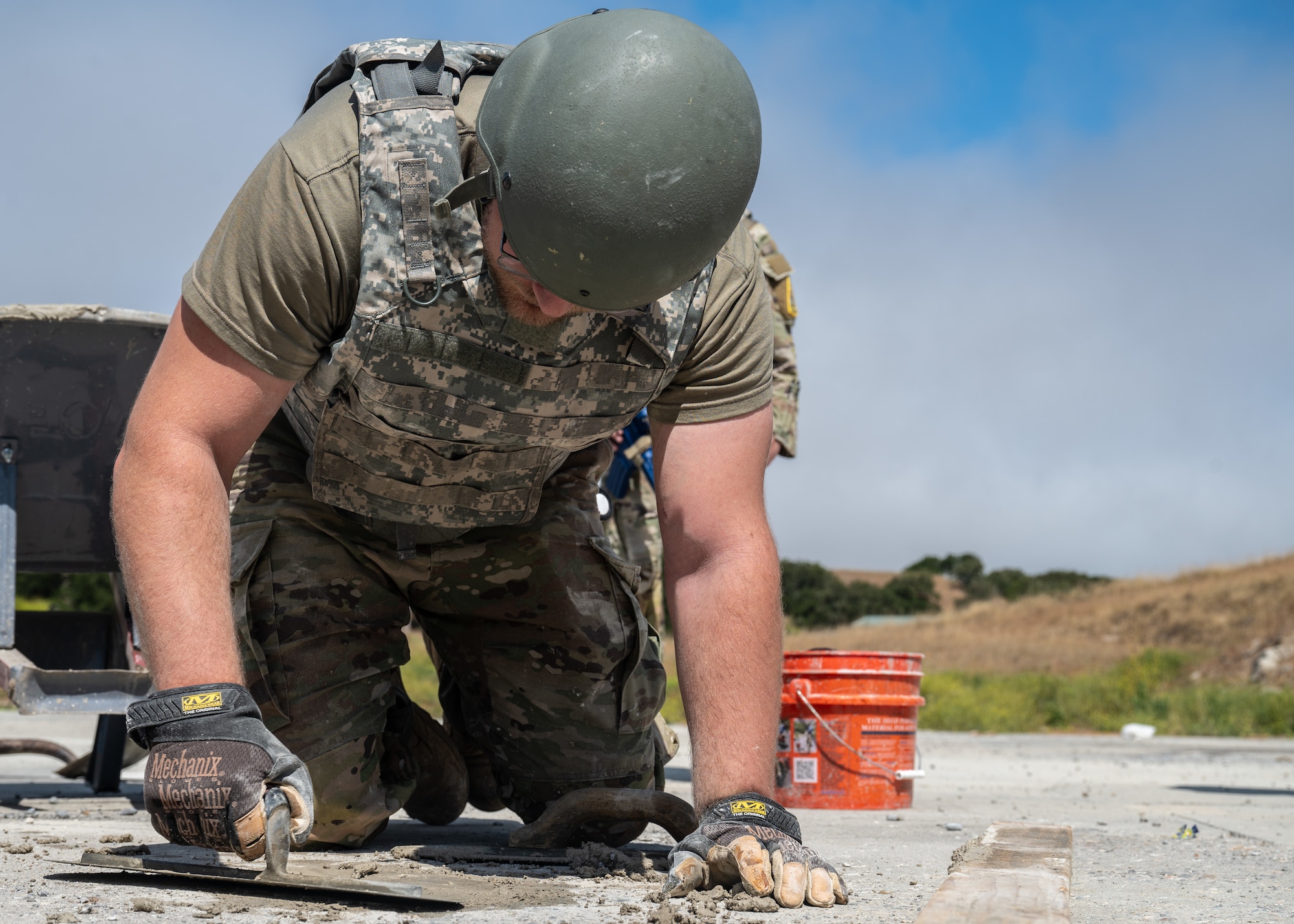 An Airman assigned to the 30th Civil Engineer Squadron lays and flattens concrete into a spall during 30 CES’s Prime Base Engineer Emergency Force Day event at Vandenberg Space Force Base, Calif., June 26, 2025. Members of 30 CES trained on a variety of core competencies to include rapid airfield damage repair, base buildup, and tactical combat casualty care.