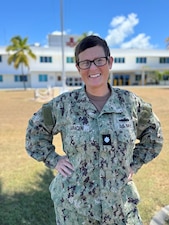 250516-N-LY941-1002
GUANTANAMO BAY, Cuba (May 16, 2025) – Cmdr. Crystal Saraceni, a member of U.S. Navy Medicine Readiness and Training Command, Guantanamo Bay, stands in front of U.S. Naval Hospital Guantanamo Bay, May, 16, 2025. Saraceni is a Clinical Nurse Specialist, Director of Clinical Support Services, and Chief Nursing Informatics Officer at the hospital, and earned the 2025 Defense Health Agency Annual Nursing Award. (U.S. Navy photo by Emily McCamy)