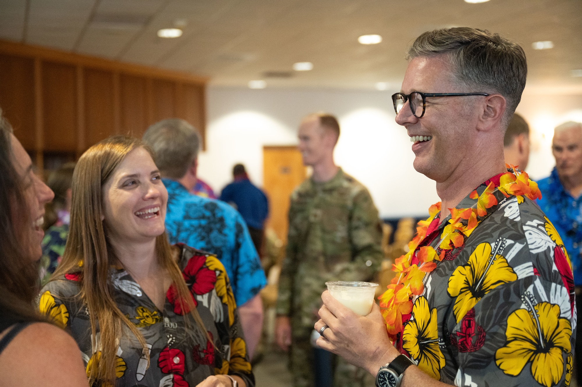 U.S. Air Force Chief Master Sgt. Michael Becker, 355th Wing senior enlisted leader, talks with partygoers during a farewell party for him and U.S. Air Force Col. Scott Mills, 355th Wing commander, at Davis-Monthan Air Force Base, June 25, 2025. The event ended with speeches, a blooper reel and gifts given from across the 355th Wing. (U.S. Air Force photo by Airman Jaden Kidd)
