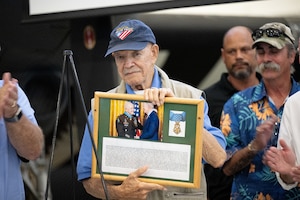 Retired U.S. Army Col. Paris Davis, Medal of Honor recipient, holds his plaque during a MOH plaque dedication ceremony at the Air Mobility Command Museum on Dover Air Force Base, Delaware, June 21, 2025.