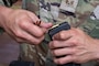 A U.S. Air Force Airmen loads a magazine for an M4 carbine rifle during combat arms training and maintenance.