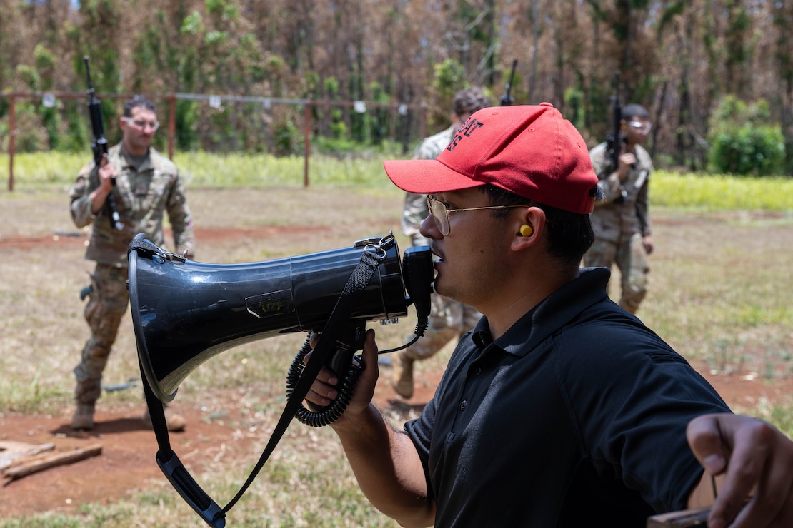 A U.S. Air Force combat arms training and maintenance instructor gives instructions to Airmen.
