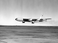 black and white photo of the first B-52 coming in for landing