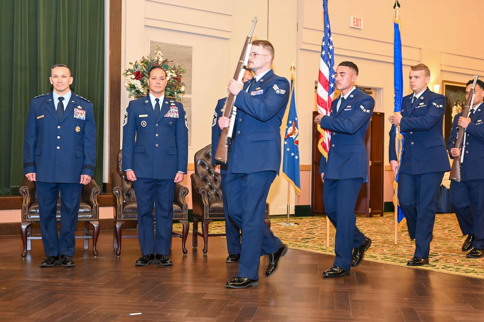 Honor Guard walks on stage with colors.