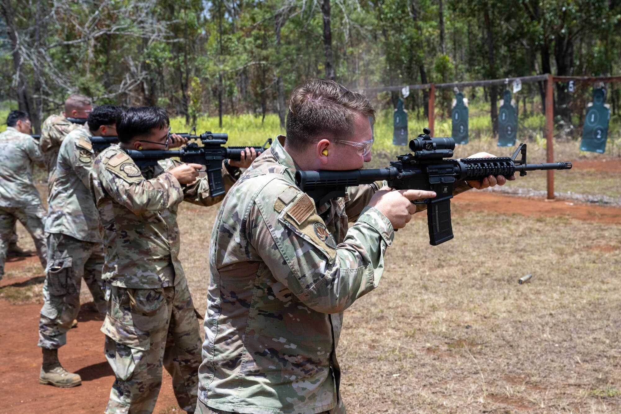 U.S. Air Force Airmen fire their M4 carbine rifles at practice targets during combat arms training and maintenance.