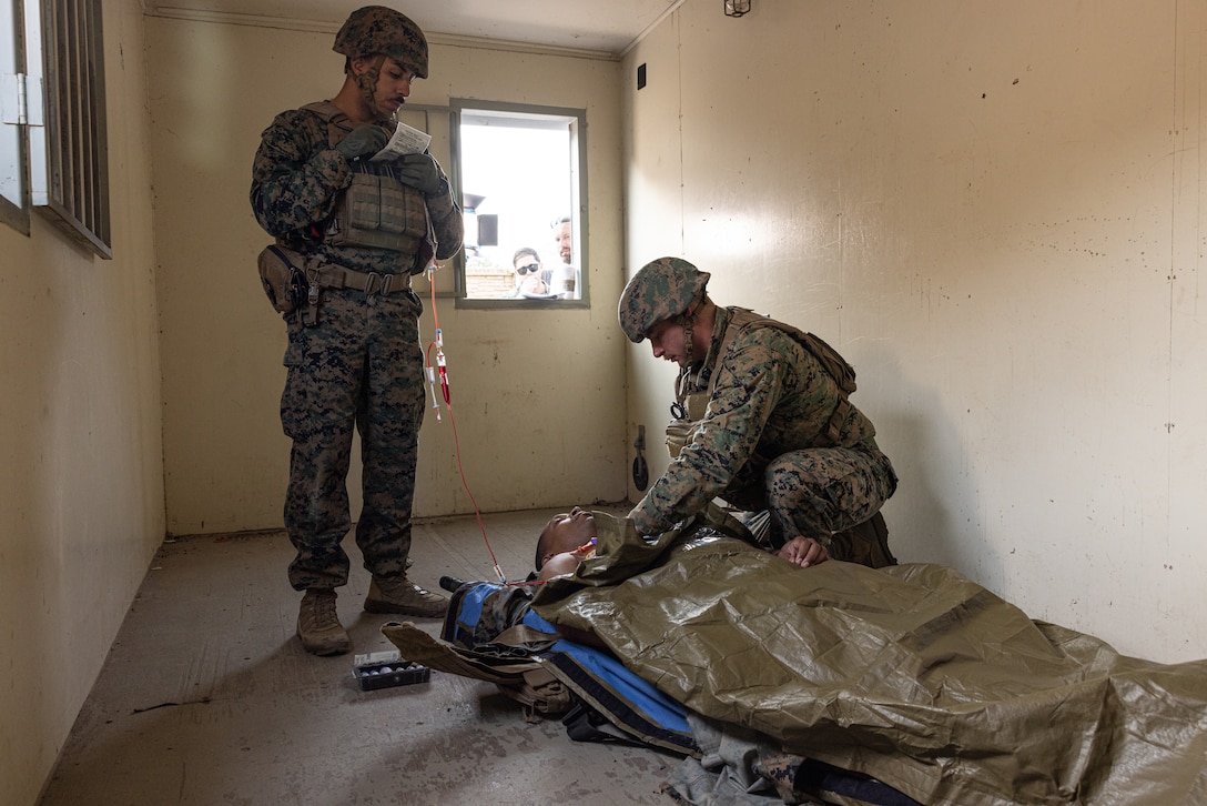U.S. Marine Corps Sgt. Joe Malavez, left, a native of Worcester, Massachusetts, documents medical information given by U.S. Navy Petty Officer 1st Class Chad Wardrip, a native of Baytown, Texas, both instructors with Field Medical Training Battalion – West, during the filming of an instructional media production at Camp Pendleton, California, July 25, 2024. (U.S. Marine Corps photo by Lance Cpl. James Bricker)