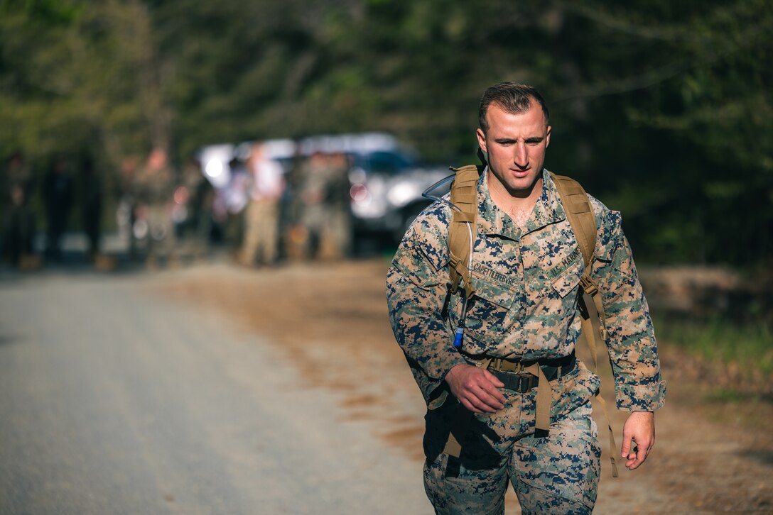 U.S. Marine Corps Staff Sgt. Lucas Capetti-Lefebvre, a Wisconsin native and combat diver instructor with Marine Aviation Training Support Group 21, conducts a ruck march during the Fittest Instructor Competition on Marine Corps Base Quantico, Virginia, April 22, 2024. The Fittest Instructor competition brings Marines from different units together to compete in a variety of events to include, a blind ruck march, a swimming competition, strength and endurance exercises, a Royal Marine physical fitness test, a modified biathlon, and Kim’s double obstacle course. (U.S. Marine Corps photo by Lance Cpl. Joaquin Dela Torre)
