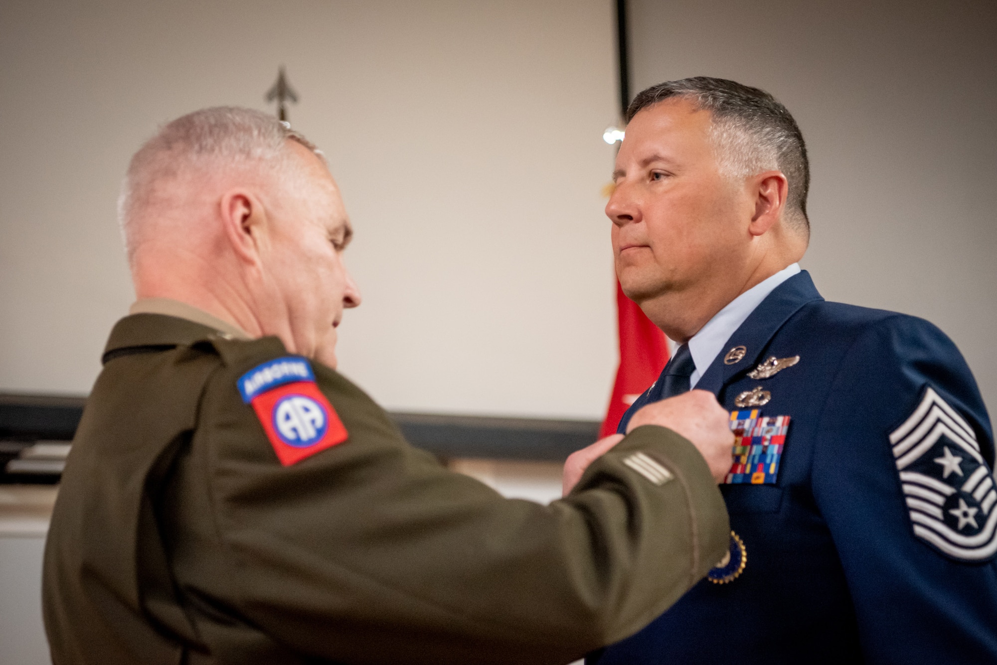 Chief Master Sgt. James Tongate, right, Kentucky Air National Guard state command chief, is pinned with the Kentucky Distinguished Service Medal by U.S. Army Maj. Gen. Haldane Lamberton, Kentucky’s adjutant general, during Tongate’s retirement ceremony at the Kentucky Air National Guard Base in Louisville, Ky., April 13, 2025. Tongate served the U.S. military for 33 years. (U.S. Air National Guard photo by Master Sgt. Joshua Horton)