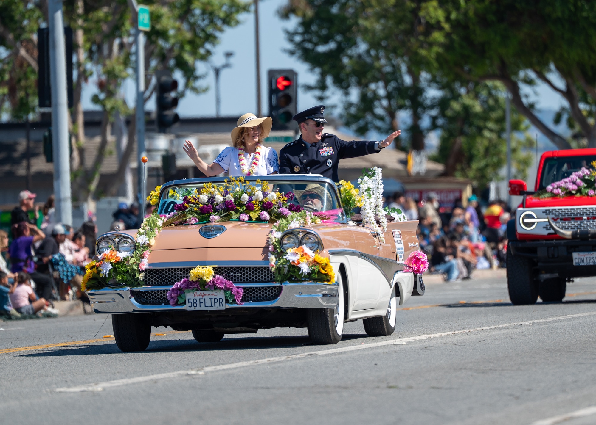 U.S. Space Force Lt. Gen. Douglas Schiess, U.S. Space Forces - Space commander and the Combined Joint Force Space Component Commander, and his wife Debbie, wave to the crowd during the Lompoc Flower Festival Parade in Lompoc, Calif., June 28, 2025.  Leadership from U.S. Space Forces - Space and Space Launch Delta 30 participated in the parade which had over 50 entrees and 500 attendees.