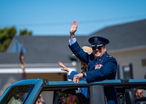 U.S. Space Force Col. Dorian Hatcher, Space Launch Delta 30 deputy commander, waves to the crowd at the Lompoc Flower Festival parade in Lompoc, Calif., June 28, 2025. Leadership from U.S. Space Forces - Space and Space Launch Delta 30 participated in the parade which had over 50 entrees and 500 attendees.