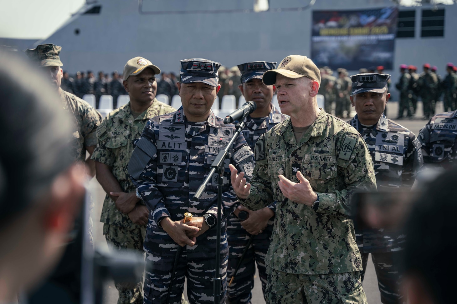 250623-N-CM740-1463 SURABAYA, Indonesia (June 23, 2025) - U.S. Navy Capt. Matt Scarlett, commodore, Destroyer Squadron Seven, right, and Rear Adm. I Gung Putu Alit Jaya, commander in chief, 2nd Fleet, Indonesian Navy, speak to the media during a press conference after the conclusion of the opening ceremony of Cooperation Afloat Readiness and Training (CARAT) Indonesia 2025 at Tentara Nasional Indonesia Angkatan Laut (TNI-AL) headquarters in Surabaya, Indonesia, June 23, 2025. CARAT Indonesia is a bilateral exercise between Indonesia and the United States designed to promote regional security cooperation, maintain and strengthen maritime partnerships, and enhance U.S. and partner navies’ abilities to operate together in response to maritime security challenges in the Indo-Pacific region (U.S. Navy photo by Mass Communication Specialist 1st Class Robert Stamer)