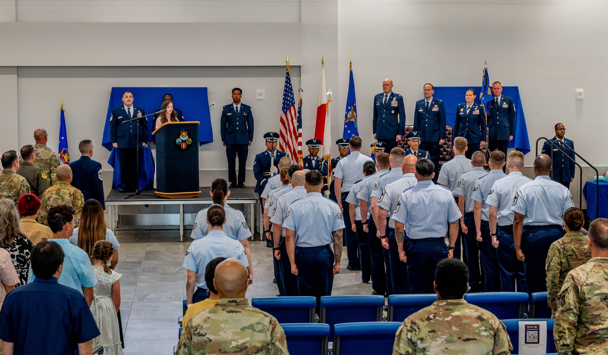Attendees stand for the presentation of colors.