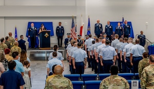 Attendees stand for the presentation of colors.