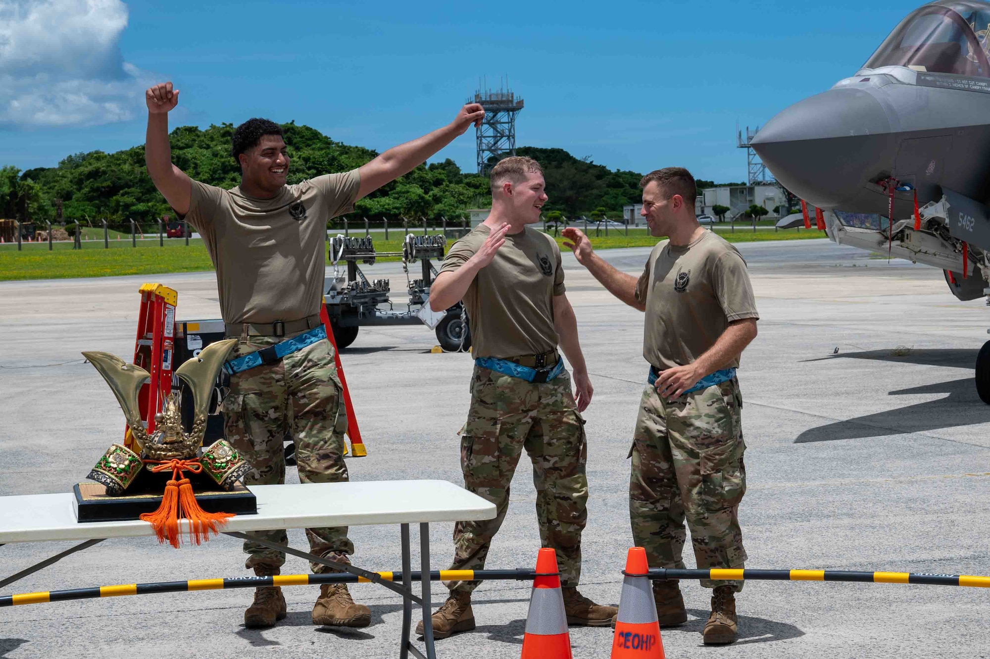 service members cheer after winning a competition