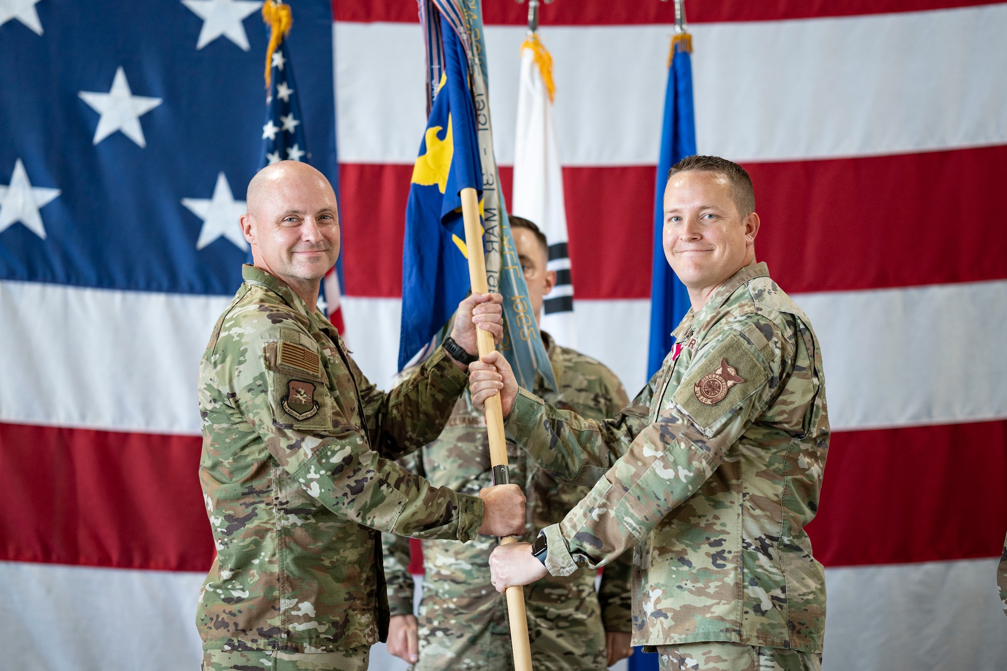 U.S. Air Force Col. Jeff Elliott, left, 51st Civil Engineering Group commander, receives the guidon from Lt. Col. Andrew Myers, right, outgoing 51st Civil Engineering Squadron commander, during a Change of Command ceremony at Osan Air Base, Republic of Korea, June 30, 2025.