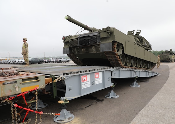 A tank is offloading from a rail car using a modular RAIL system that provides a temporary ramp suitable for use by heavy equipment.
