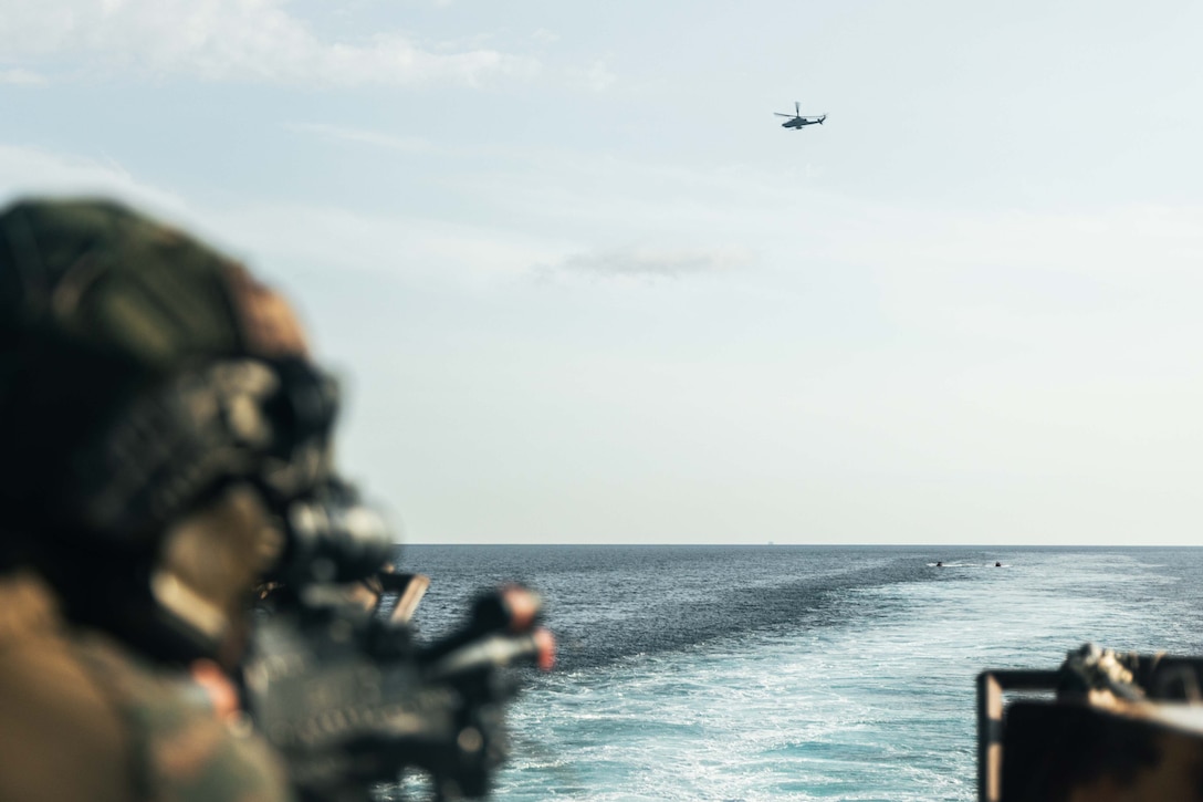 U.S. Marine Corps Lance Cpl. Thomas Sio, a machine gunner with Weapons Company, Battalion Landing Team 3/6, 22nd Marine Expeditionary Unit (Special Operations Capable), holds security during a Defense of the Amphibious Task-Force exercise as part of Composite Training Unit Exercise aboard the San Antonio-class amphibious transport dock ship USS San Antonio (LPD 17), Iwo Jima Amphibious Ready Group, while underway in the Atlantic Ocean, June 26, 2025. During COMPTUEX, the IWOARG and 22nd MEU (SOC), refine tactics, techniques, and procedures to execute warfighting functions that enhance operational readiness and lethality as a unified IWOARG/22 MEU (SOC) team. (U.S. Marine Corps photo by Cpl. Maurion Moore)
