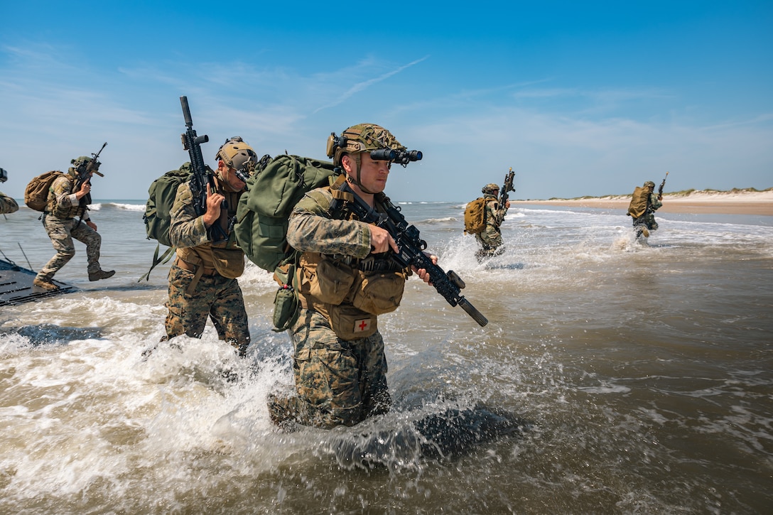 U.S. Marines disembark from a Netherlands Navy Landing Craft Vehicle Personnel (LCVP) performing an amphibious landing at Onslow Beach, Camp Lejeune, North Carolina, June 24, 2025. Atlantic Alliance 25 is the premier naval integration exercise on the East Coast, featuring more than 25 U.S. Navy and Marine Corps units alongside Dutch naval forces and British Royal Commandos. The exercise spans sites from North Carolina to Maine and showcases a range of dynamic events, including force integration, air assault operations, bilateral reconnaissance, naval strait transits, amphibious assault training, and a simulated war-at-sea exercise. (Netherlands Maritime Force photo by OR-7 Cristian Schrik)