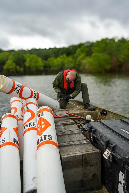 Nolin River Lake Park Ranger Matt Skaggs works to reinstall regulatory buoys near the Dogcreek Campground June 2, 2025, following Nolin's second-highest flood on record.