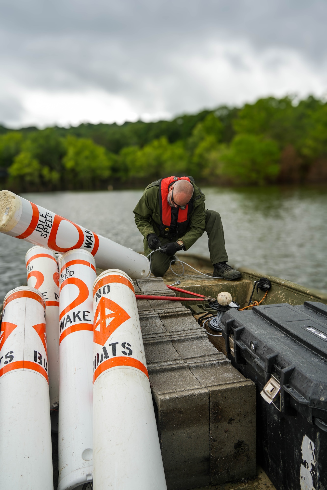 Nolin River Lake Park Ranger Matt Skaggs works to reinstall regulatory buoys near the Dogcreek Campground June 2, 2025, following Nolin's second-highest flood on record.