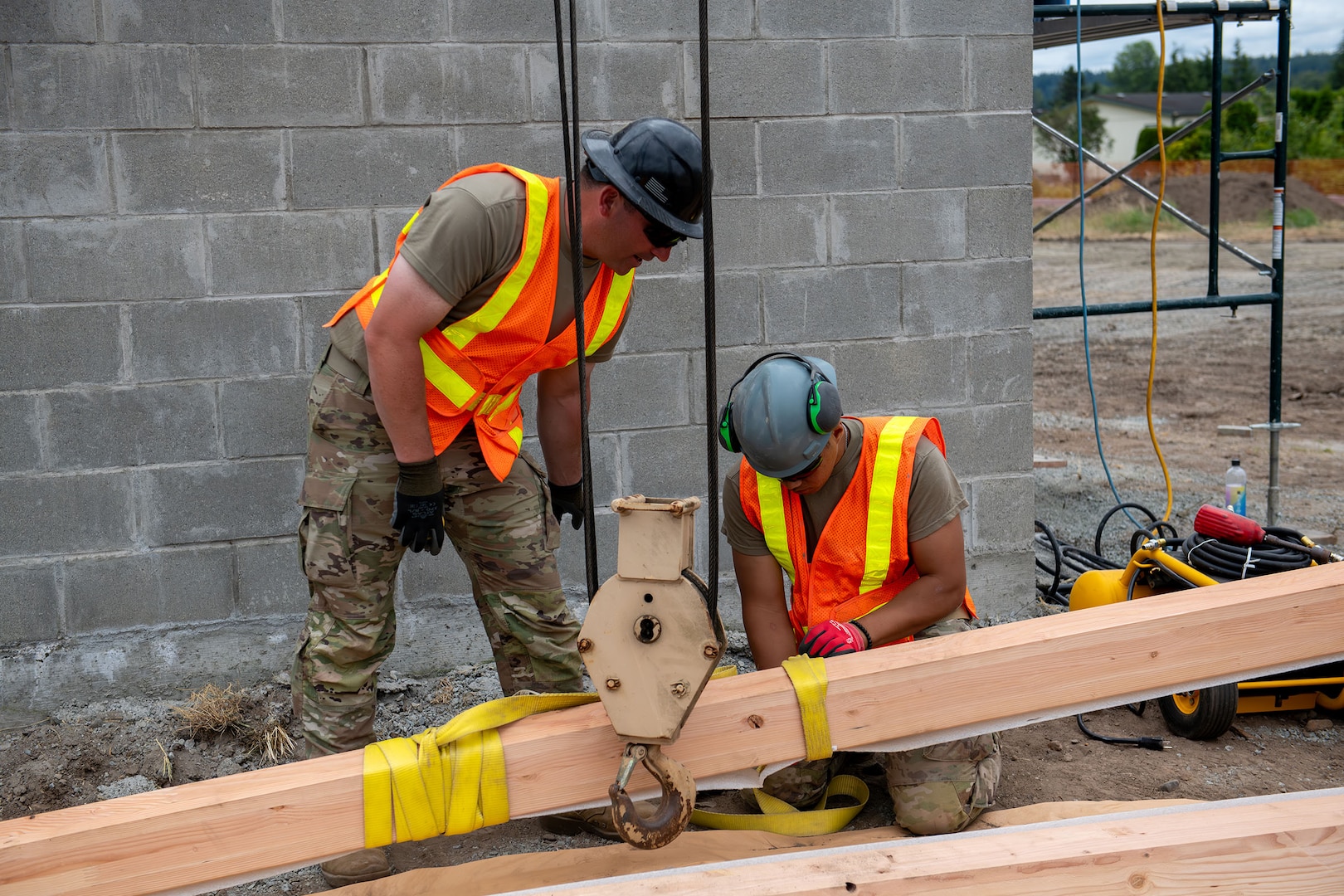 U.S. Army Staff Sgt. Zachary Williamson, left, and Spc. Pharez Telona, with the 176th Engineer Company, 420th Chemical Battalion, 96th Troop Command, Washington National Guard, prepares the beam for installation on the roof of a restroom facility at Charter Park, Orting, Wash, June 19, 2025.