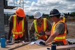 U.S. Army Staff Sgt. Zachary Williamson, right, with the 176th Engineer Company, 420th Chemical Battalion, 96th Troop Command, Washington National Guard, is instructing Soldiers in his unit about tongue and groove roof decking for the restroom facility at Charter Park, Orting, Wash, June 19, 2025. 176th Eng. Co. is partnering with the city of Orting through the Innovative Readiness Training program, a Department of Defense initiative that enables Soldiers to receive training and acquire new skills while providing valuable services to their local communities.