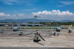 U.S. Air Force and Guatemalan Aircraft stage for a photo during CENTAM Guardian 25, May 20, 2025. Pictured in the photo, from left to right, are a Guatemalan Bell 412 helicopter, a U.S. C-130 Hercules, a Guatemalan Cessna 208 Caravan, a U.S. CH-47 Chinook, a Beechcraft 200 King Air, a U.S. C-130 Hercules, and a Guatemalan Bell 212 helicopter.