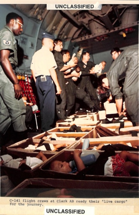 Historical photo of C-141 flight crews at Clark Air Base, Philippines, readying their "live cargo" for the journey. (Courtesy photo)