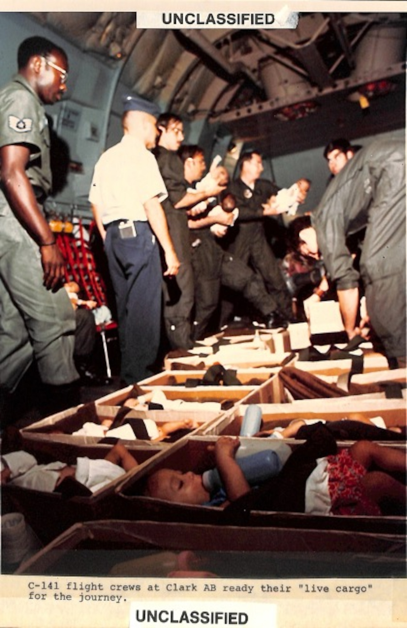 Historical photo of C-141 flight crews at Clark Air Base, Philippines, readying their "live cargo" for the journey. (Courtesy photo)