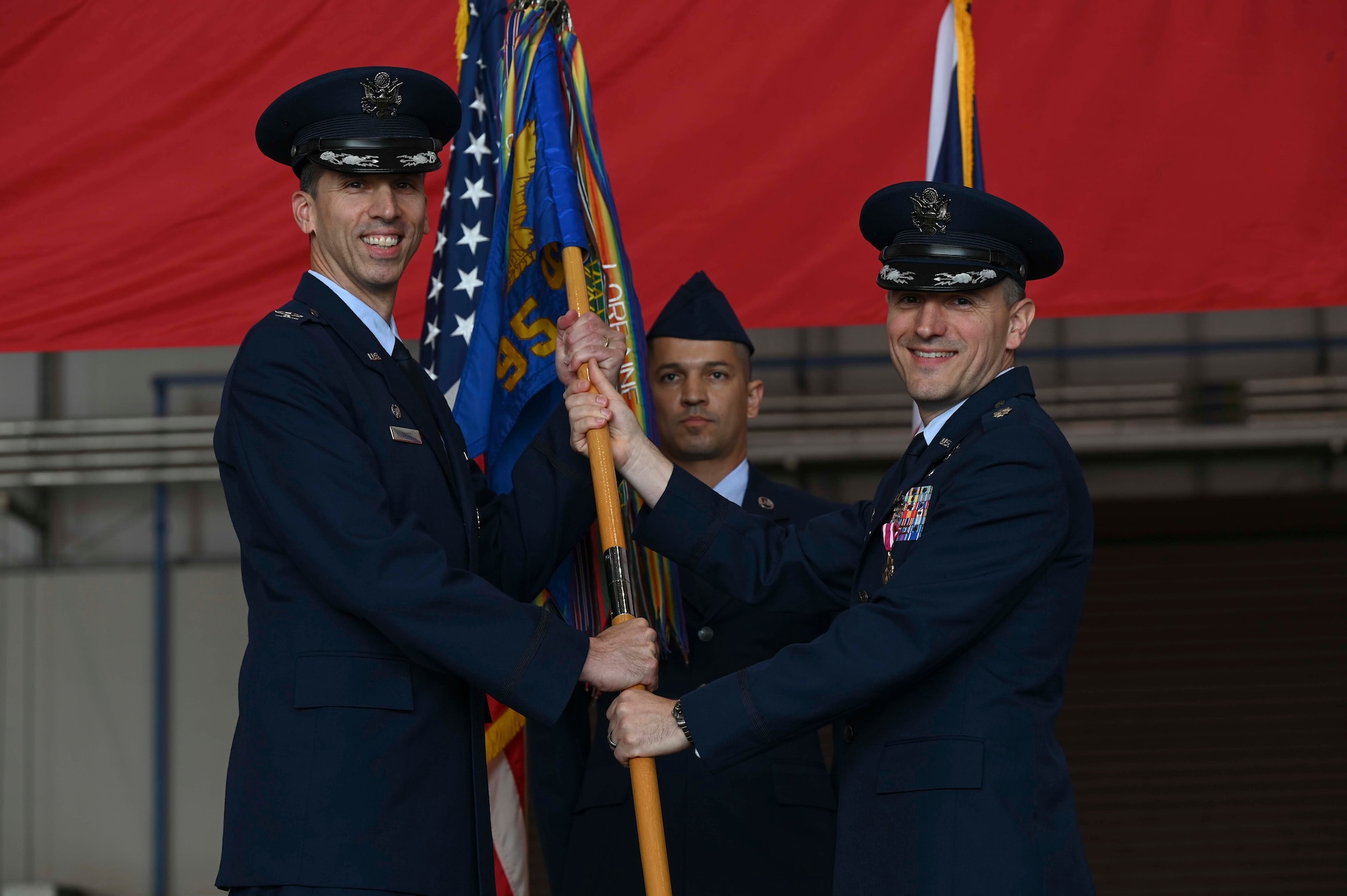 The ceremony presents a visible transfer of authority from the departing commander to the new commander.