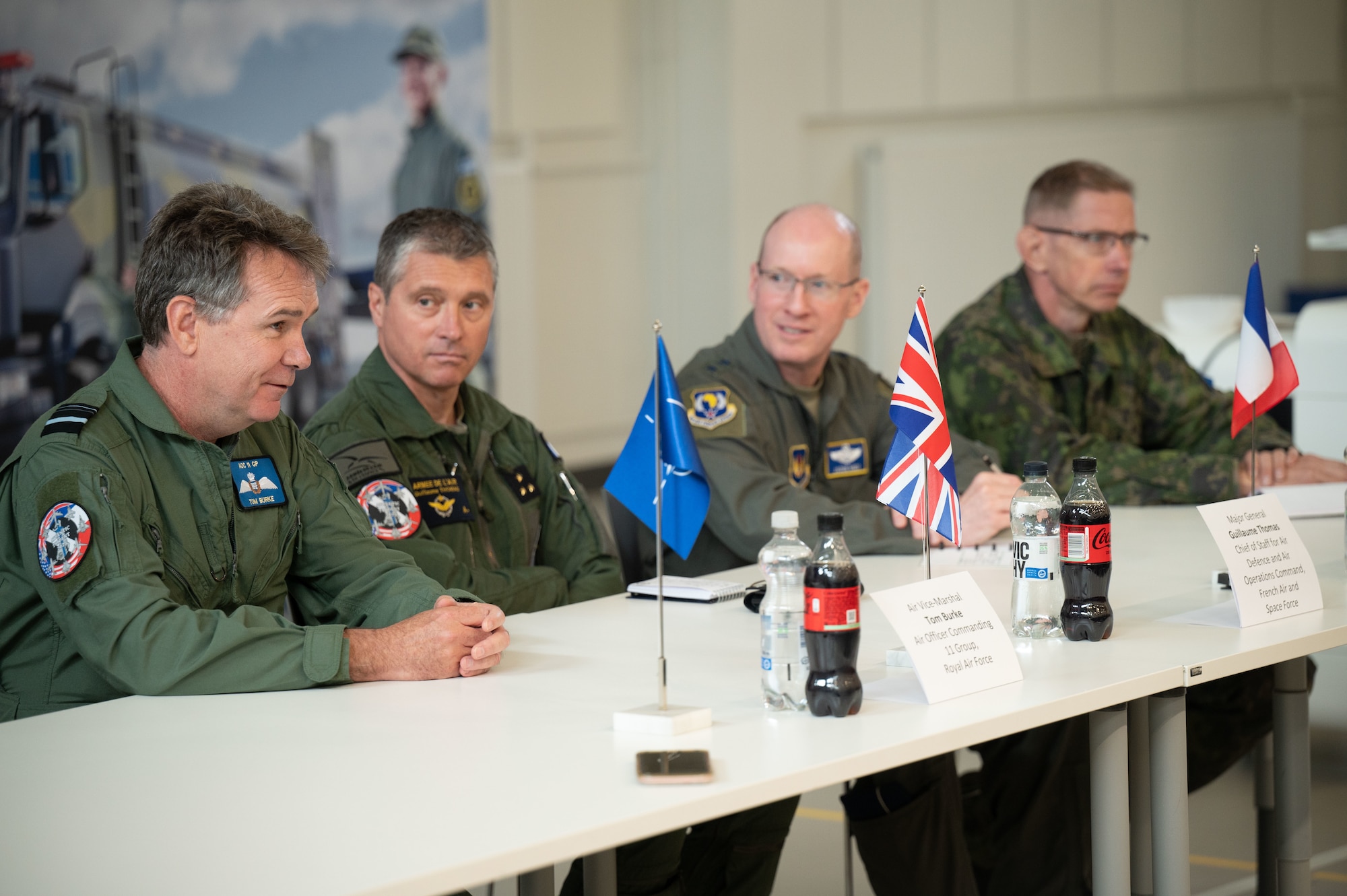 From left, Royal Air Force Air Vice Marshall Tom Burke, Air Officer Commanding 11 Group, French Air and Space Force Maj. Gen. Guillaume Thomas, Air Defense and Air Operations chief of staff, U.S. Air Force Lt. Gen. Jason Hinds, U.S. Air Forces in Europe - Air Forces Africa deputy commander, and Finnish Air Force Maj. Gen. Timo Herranen, Commander of the Finnish Air Force, discusses exercise Atlantic Trident 25 mission successes at Pirkkala Air Base, Finland, June 26, 2025. AT 25 focused on integrated operations with NATO Allies to ensure the Alliance is capable of projecting lethality and readiness throughout the European area of responsibility. (U.S. Air Force photo by Senior Airman Ashley Talley)