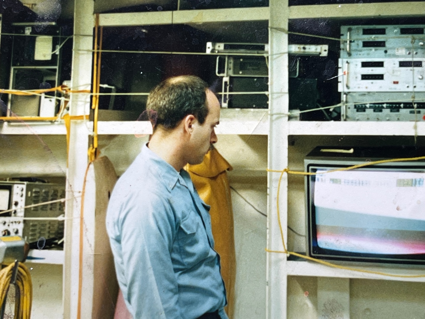 AT SEA – In 1990, Petty Officer First Class Bob Nees worked in a shop on the USS Carl Vinson (CVN 70), which was situated at the same level as the hangar deck. Nees and his team set up a color television on one of the shelves next to the spare equipment for occasional entertainment. (Bob Nees/Courtesy photo)