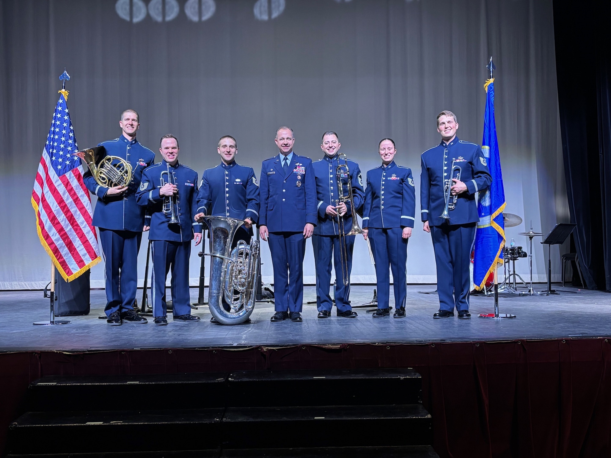 A man and 6 musicians pose for a photo.