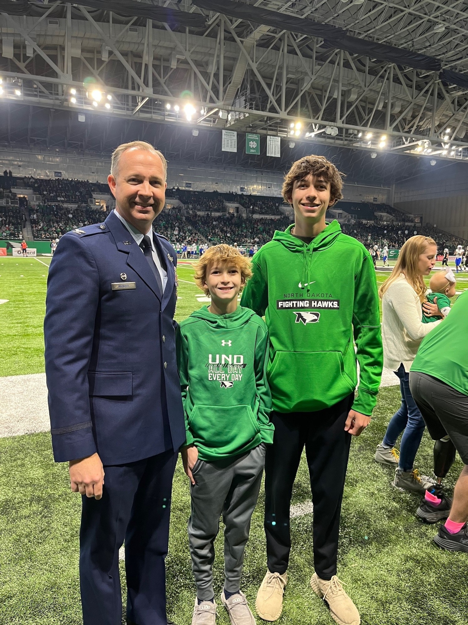 A man and two boys pose for a photo