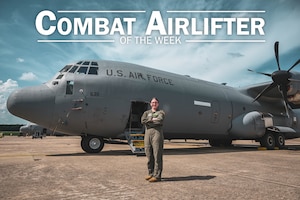 Woman poses in front of plane.