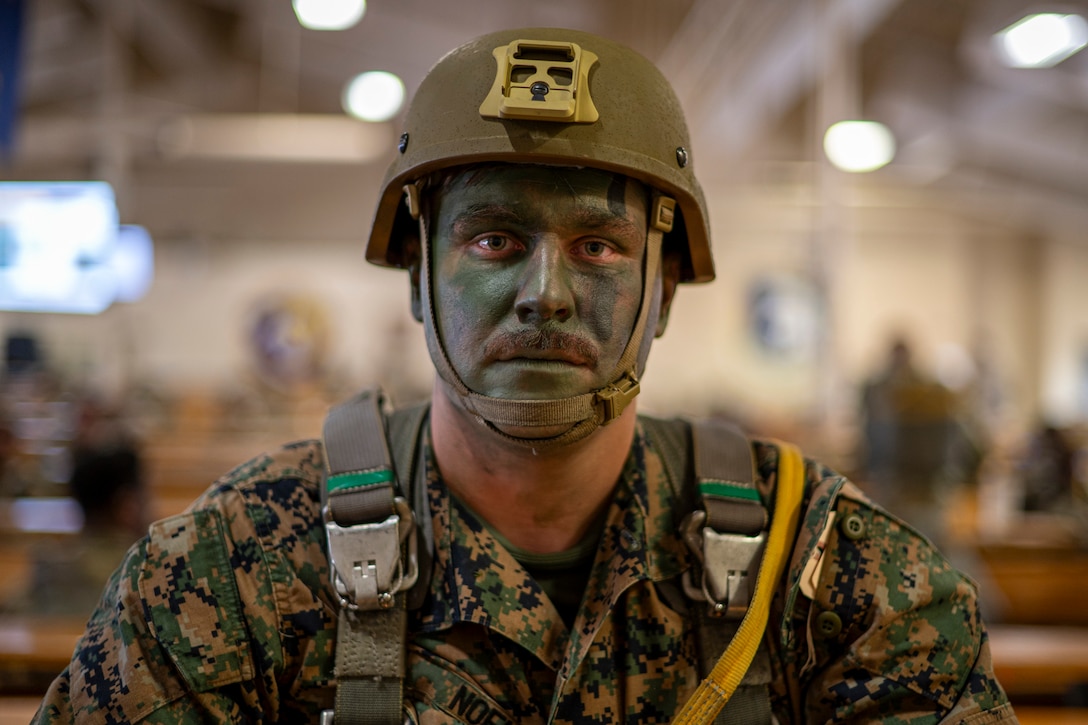 U.S. Marine Corps Sgt. Nicholas Noel, 4th Air Naval Gunfire Liaison Company field artillery fire control Marine, waits to board a C-130 Hercules for a static line jump during Red Flag-Alaska 25-2 at Joint Base Elmendorf-Richardson, Alaska, June 25, 2025. This exercise simulates the complexities of potential Indo-Pacific scenarios, providing unique opportunities to integrate various forces into joint, coalition and multilateral training from simulated forward operating bases, enhancing the U.S. and allies’ ability to respond effectively to contingencies in the region. (U.S. Air Force photo by Senior Airman Matthew Arachikavitz)