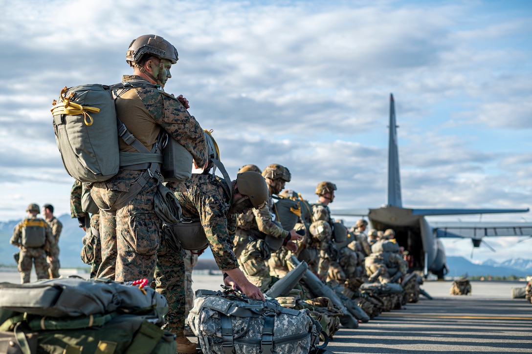 U.S. Army Soldiers assigned to the 11th Airborne Division and U.S. Marines assigned to the 4th Air Naval Gunfire Liaison Company wait to board a C-130 Hercules for a static line jump during Red Flag-Alaska 25-2 at Joint Base Elmendorf-Richardson, Alaska, June 18, 2025. This exercise simulates the complexities of potential Indo-Pacific scenarios, providing unique opportunities to integrate various forces into joint, coalition and multilateral training from simulated forward operating bases, enhancing the U.S. and allies’ ability to respond effectively to contingencies in the region. (U.S. Air Force photo by Senior Airman Matthew Arachikavitz)