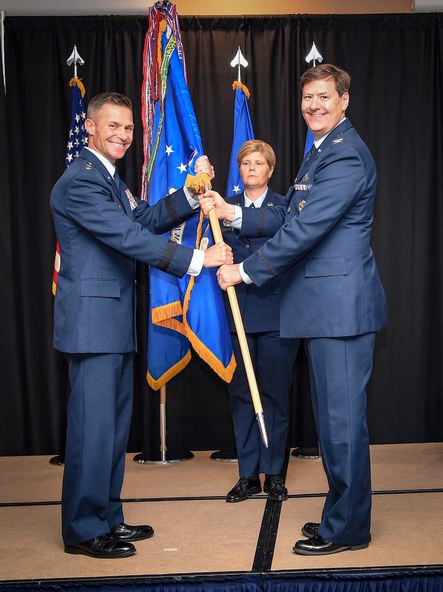 Two Air Force members hold a guidon for the 363d Intelligence, Surveillance, and Reconnaissance Wing.