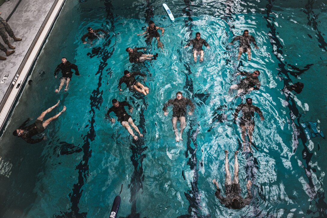 U.S. Marines with the Special Purpose Marine Air-Ground Task Force – Alert Contingency MAGTF and 26th Marine Expeditionary Unit conduct water treading drills during a Water Survival Advanced course at Camp Lejeune, North Carolina, June 3, 2025. WSA training is a week-long course that prepares Marines and Sailors for execution of emergency activation plans, water survival and rescue scenarios, and risk mitigation employment. (U.S. Marine Corps photo by Cpl. Osmar VasquezHernandez)