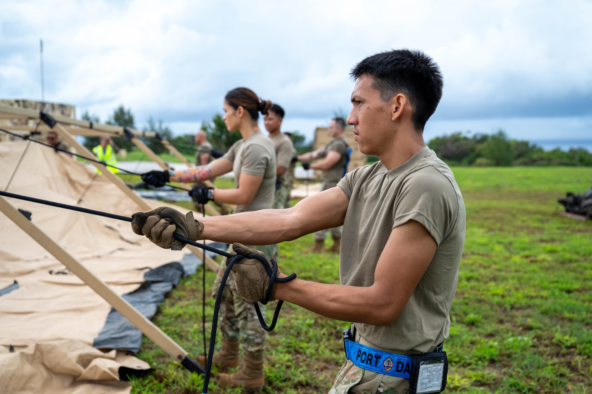 Senior Airman Josiah Cruz, an air transportation specialist with the 44th Aerial Port Squadron, applies tension to a rope to assist during Exercise Pacific Warrior 2025 at Andersen Air Force Base, Guam, June 6, 2025.