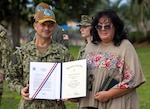 Naval Surface Warfare Center Panama City Division Commanding Officer Capt. Paul Stence, Jr., awards Geri Kohler, NSWC PCD military liaison, with the Department of the Navy Meritorious Civilian Service Award, June 13. Kohler manages all active-duty personnel and their administrative functions warfighters to seamlessly mesh and support the mission here while ensuring their operational readiness. (U.S. Navy photo by Bob Lindee)