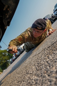 Staff Sgt. Ryan Cutler, 78th SFS conducts vehicle inspections at Robins AFB as part of the installation's random anti terrorism measures, searching for suspicious packages and unusual activity to protect Team Robins members.