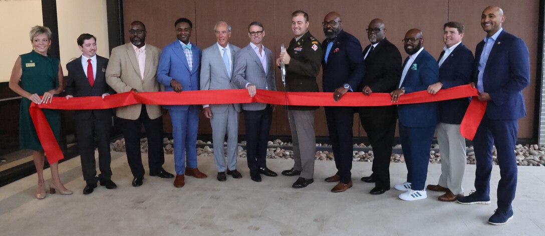 Picture of several people doing a ribbon cutting.