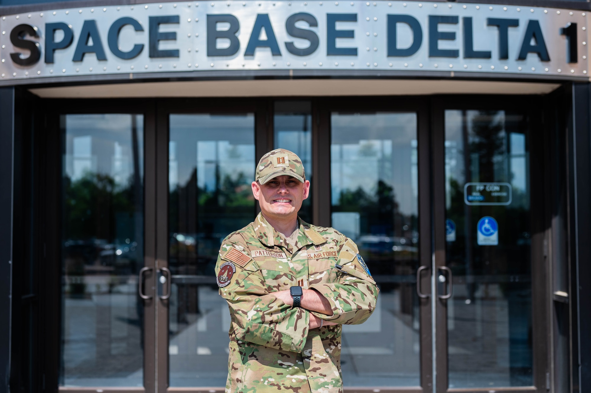 Capt. Ian Patterson poses for a photo in front of the Space Base Delta 1 headquarters building at Peterson Space Force Base.