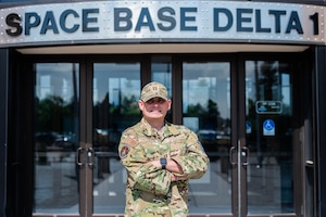 Capt. Ian Patterson poses for a photo in front of the Space Base Delta 1 headquarters building at Peterson Space Force Base.