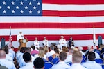 U.S. Coast Guard member speaks to a crowd.